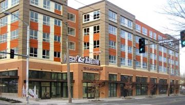 Seattle apartment for rent - a large building on the corner of a street with a traffic light