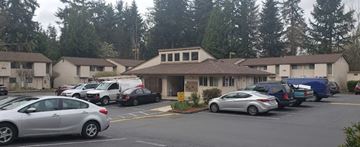 Bellevue apartment for rent - a parking lot filled with cars in front of a building