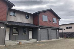 Sedro Woolley apartment for rent - a red and white house with gray garage doors