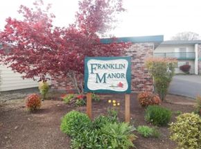 St Helens apartment for rent - A sign that says Franklin Manor in front of a building.