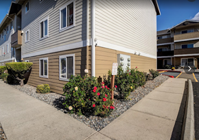 East Wenatchee apartment for rent - a street sign in front of a house with flowers