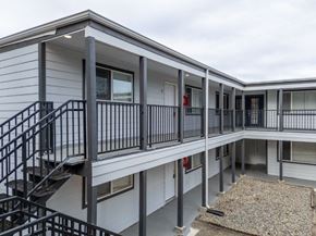 Lakewood apartment for rent - A multi-level residential building with a staircase and railings.
