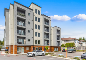 Everett apartment for rent - A modern apartment building with a grey car parked in front.