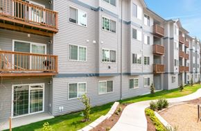 Seattle apartment for rent - Apartment complex with balconies and greenery in the front.