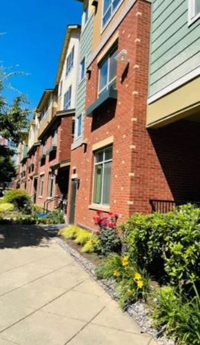 Seattle apartment for rent - A row of apartment buildings with green trim and red brick.