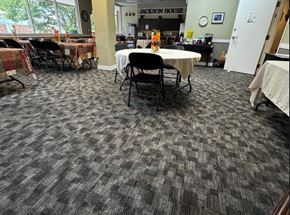 Everett apartment for rent - A room with a carpeted floor and tables with chairs.