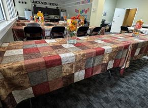 Everett apartment for rent - A room with tables covered in quilted tablecloths and a sign that says Jackson House.