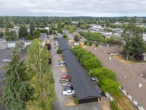 Lakewood apartment for rent - A parking lot with a long building in the middle.