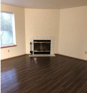Burlington apartment for rent - A living room with a fireplace and wood flooring.