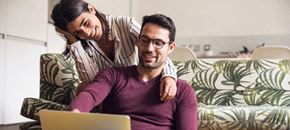 Marysville apartment for rent - a man and woman sitting on a couch looking at a laptop