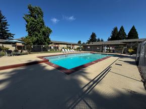 Springfield apartment for rent - A large outdoor swimming pool surrounded by a fence.