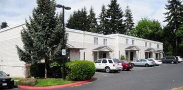 Kirkland apartment for rent - a white building with cars parked in front of it