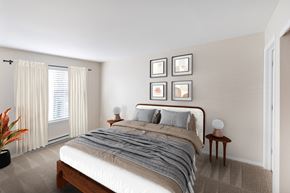 Lake Oswego apartment for rent - A bedroom with a large bed and a plant on the floor.