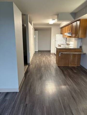 Everett apartment for rent - A kitchen with wooden cabinets and a white refrigerator.