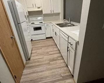 Lynnwood apartment for rent - a small kitchen with white cabinets and white appliances
