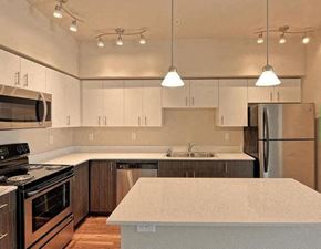 Wenatchee apartment for rent - A kitchen with a white counter top and stainless steel appliances.
