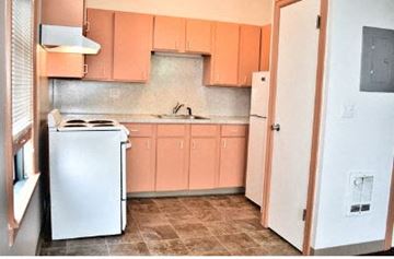 Seattle apartment for rent - a small kitchen with a stove and a refrigerator