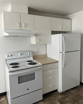Connell apartment for rent - an empty kitchen with white appliances and a refrigerator