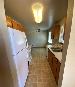 Marysville apartment for rent - a kitchen with a white refrigerator and a sink