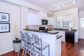 Snoqualmie townhouse for rent - A kitchen with white cabinets and a black countertop.