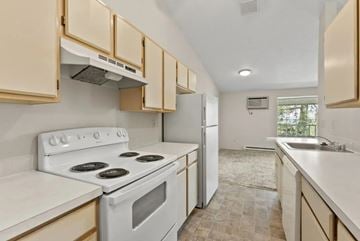 Spokane apartment for rent - A kitchen with a white stove top oven and white cabinets.