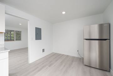 Lakewood apartment for rent - A modern kitchen with a stainless steel refrigerator and wooden flooring.