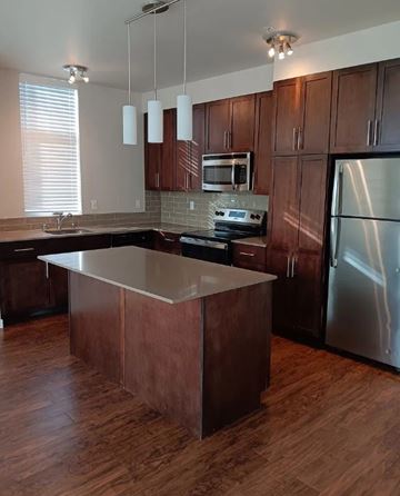Lynnwood apartment for rent - A kitchen with wooden cabinets and a stainless steel refrigerator.