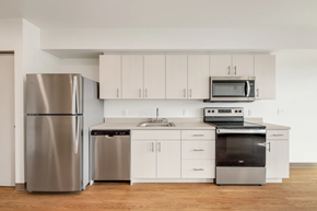 Seattle apartment for rent - a kitchen with stainless steel appliances and white cabinets