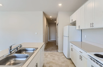 Everett apartment for rent - A kitchen with white cabinets and a sink.
