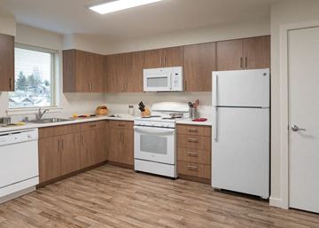 Seattle apartment for rent - a kitchen with white appliances and wooden cabinets