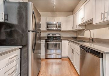 Lynnwood apartment for rent - a kitchen with stainless steel appliances and white cabinets