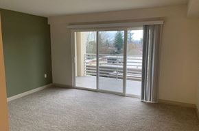 Everett apartment for rent - an empty living room with sliding glass doors to a patio
