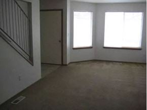 Sedro Woolley apartment for rent - an empty living room with three windows and a door