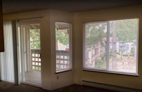 Kirkland apartment for rent - a living room with large windows and a door to a balcony