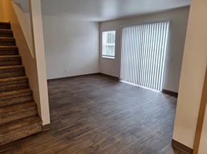 Sedro Woolley apartment for rent - an empty living room with wood floors and a staircase