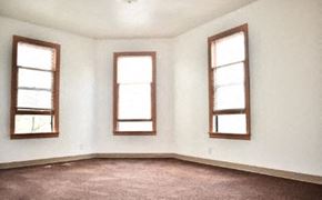 Seattle apartment for rent - a white room with three windows and a carpet