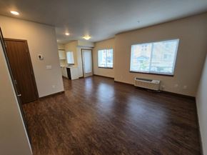 Wenatchee apartment for rent - A spacious room with wood flooring and a window.