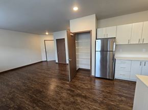 Wenatchee apartment for rent - A kitchen with white cabinets and a stainless steel refrigerator.