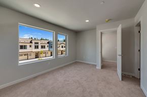 Marysville apartment for rent - A room with a carpeted floor and a view of a building through the windows.