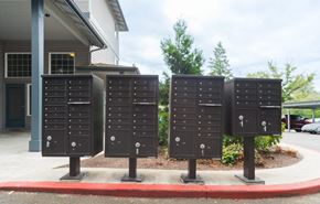Seattle apartment for rent - Three black mailboxes are lined up on a sidewalk.