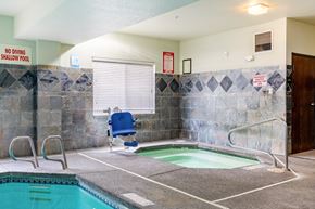 Gresham apartment for rent - A small indoor pool with a blue chair and a sign that says "No Diving Shallow Pool.".