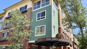 Seattle apartment for rent - a green apartment building with a columbia garden sign