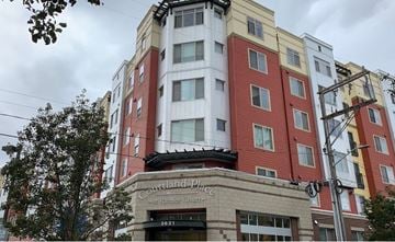 Seattle apartment for rent - a tall building with a sign on the front of it