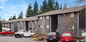 Lynnwood apartment for rent - a building with cars parked in a parking lot