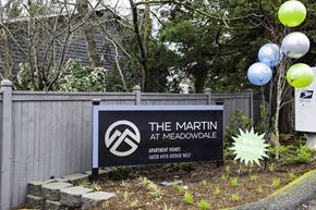 Lynnwood apartment for rent - a sign for the at meadowdale in front of a fence