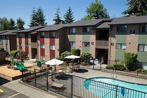 Kent apartment for rent - an apartment building with a pool and umbrellas
