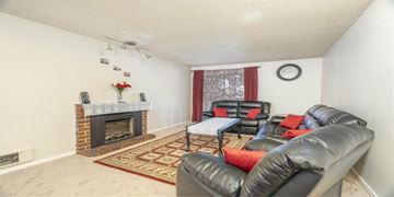 Kent apartment for rent - a living room with leather furniture and a fireplace