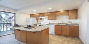 Kent apartment for rent - a kitchen with wooden cabinets and a counter top