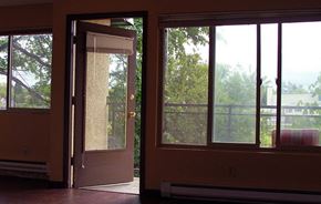 Seattle apartment for rent - a living room with a door and three windows
