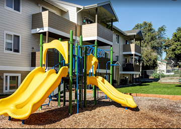 East Wenatchee apartment for rent - a playground with slides in front of a house